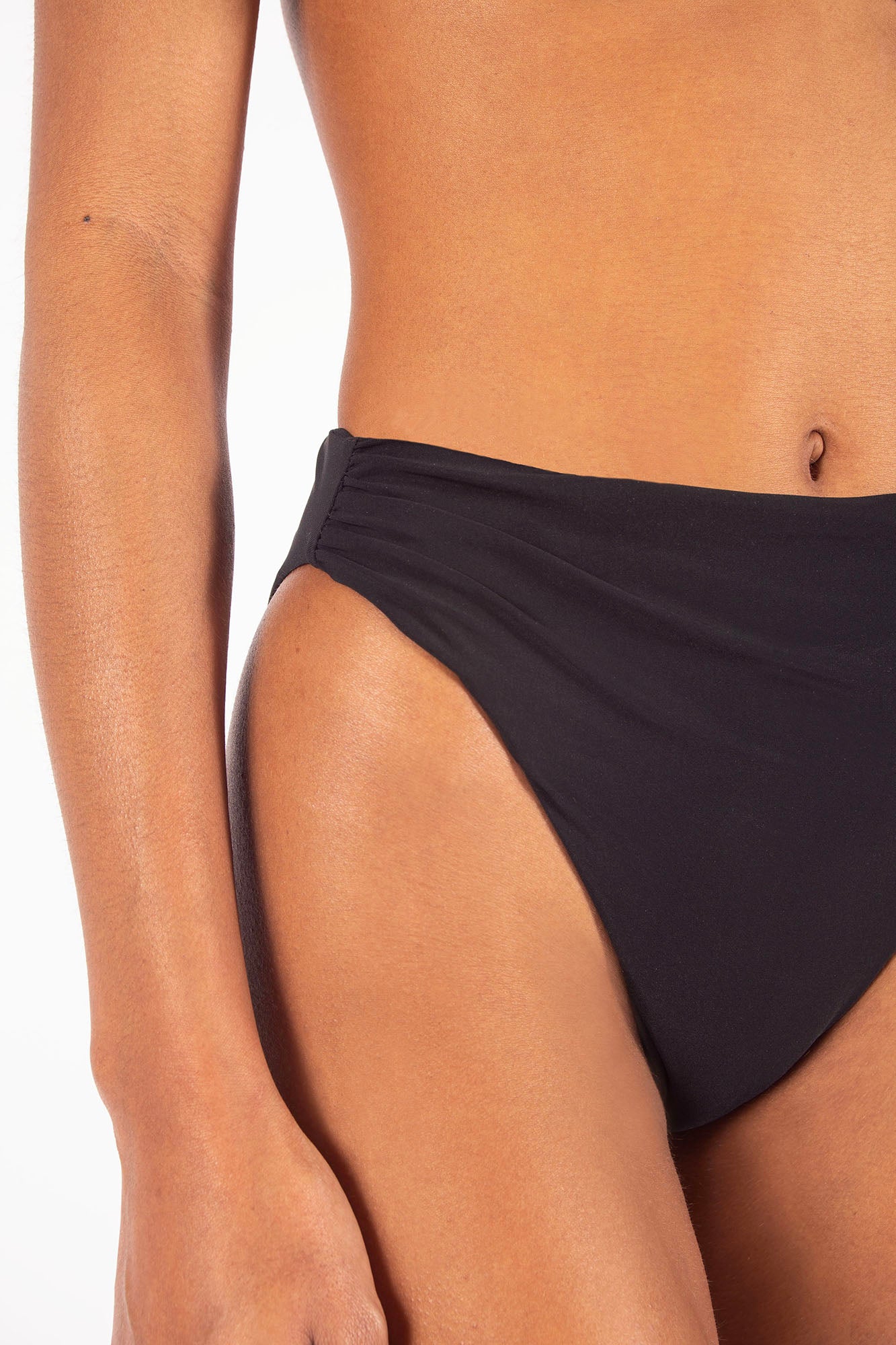 Draped Asymmetric Midi Bikini Bottom on Ecomm Model, featuring a distinctive, one-sided drape effect that translates the elegance of our ready-to-wear into swim: an irresistible mix of soigné and simplicity.