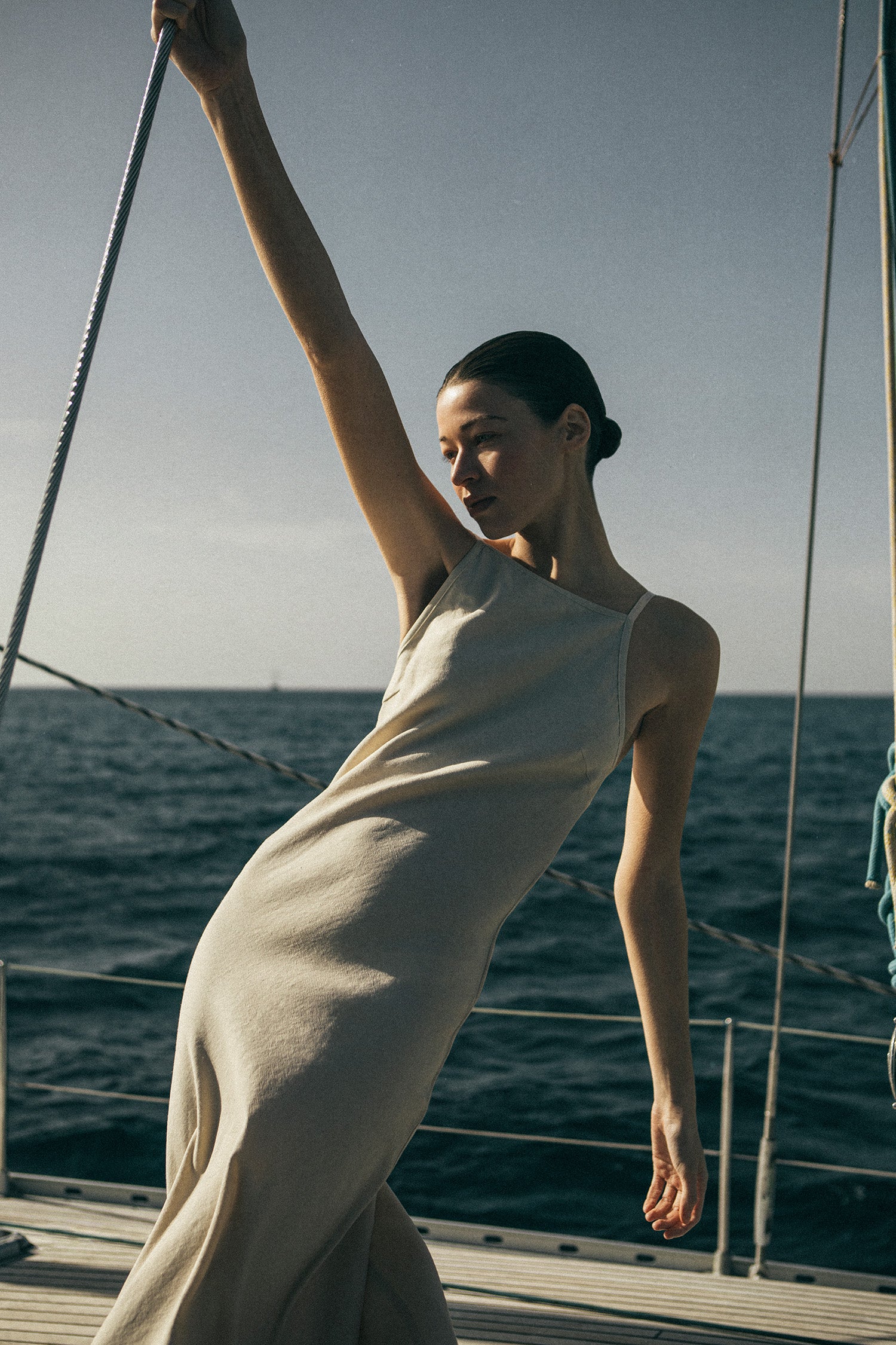 Model wearing the Gisele Bias-Cut Dress in Stretch Suiting, a a timeless, sophisticated piece made from 61% linen for breathable comfort, with just the right amount of stretch to complement all shapes.