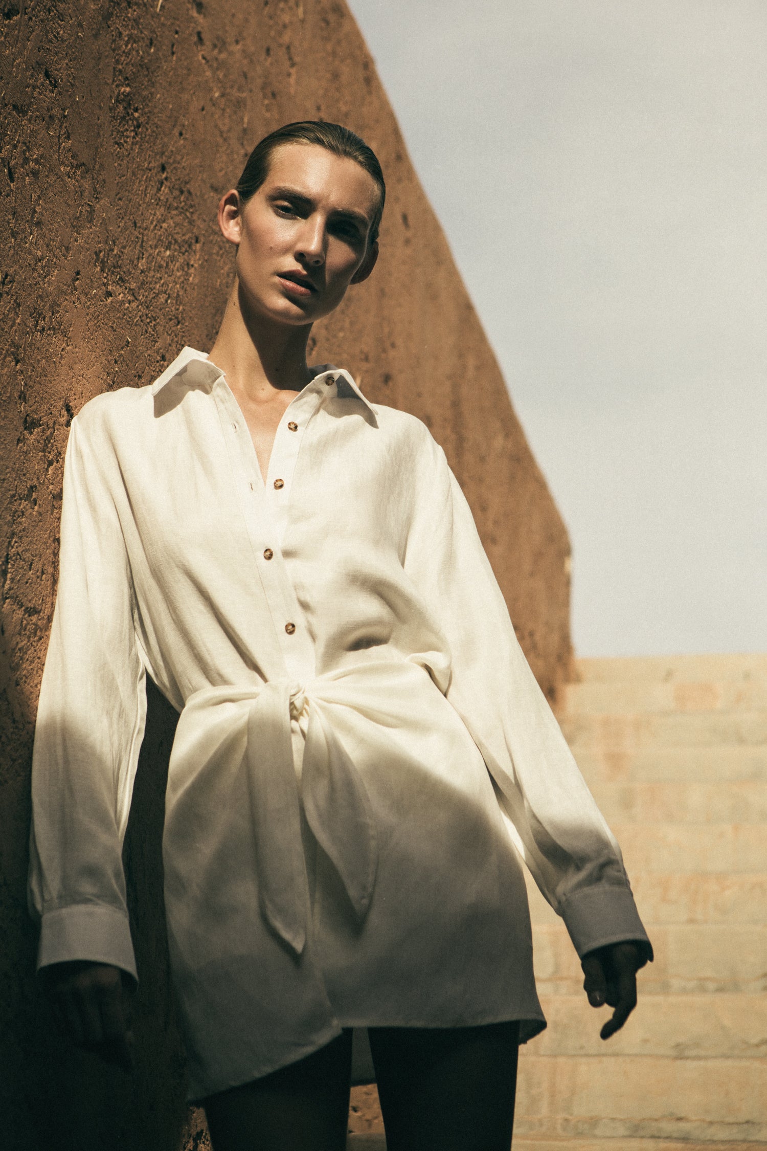 Model wearing the L.A. Button-Down Wrap Mini Dress in Cupro Linen Blend, featuring a button-down placket and chic wrap detailing along the waist.