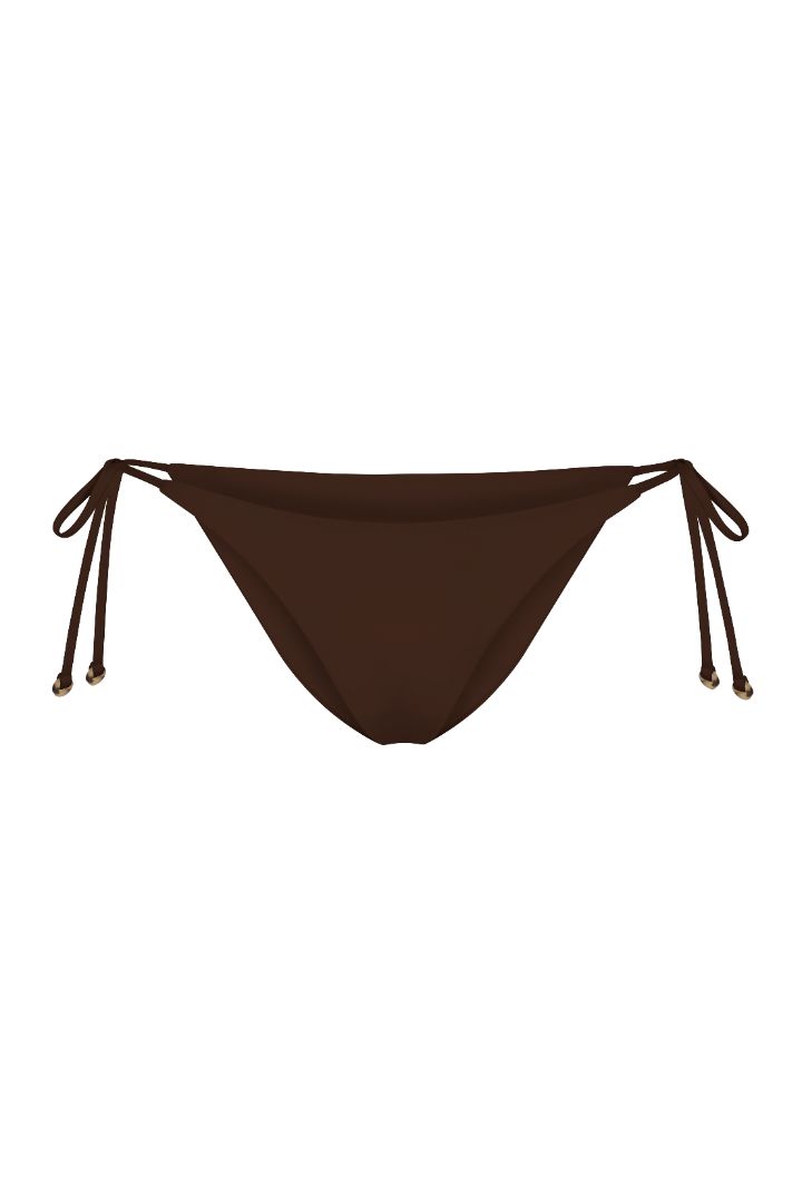 String Tie Bikini Bottom on a white background, featuring adjustable side ties with petite tortoise rings and a versatile high- or low-waist fit for a sleek ’70s-inspired look.