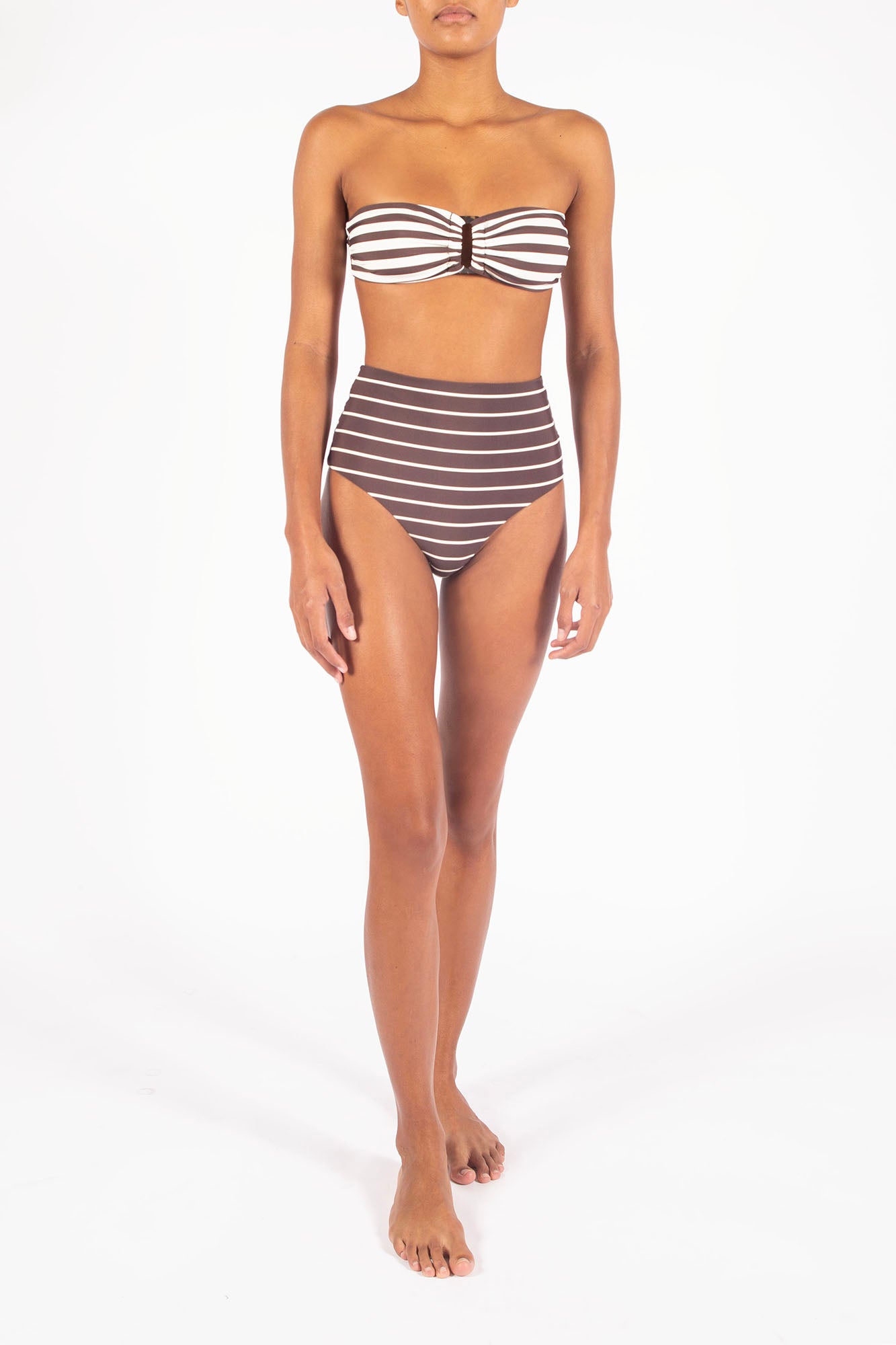 Ecomm Model wearing the Tortoise Bandeau Bikini Top In Espresso Even Stripes, featuring a classic bandeau shape elevated by a longer resin tortoise ring and a roomier fit for added comfort and support.