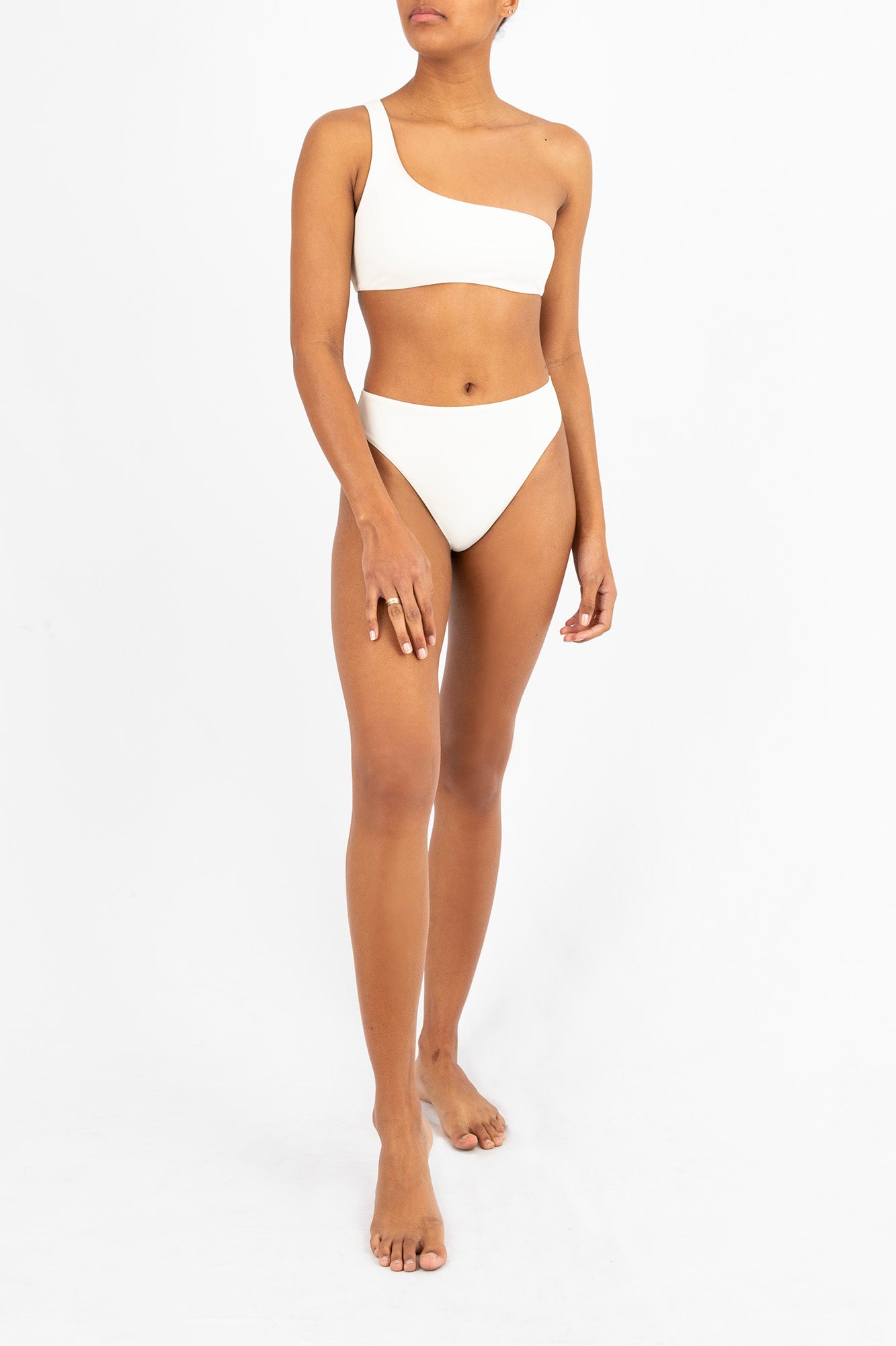 Ecomm Model wearing the One-Shoulder Bikini Top, featuring an asymmetric silhouette with a curved neckline and slender shoulder strap.