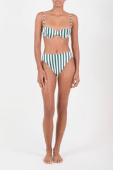 Person wearing a green and white striped bikini on a white background