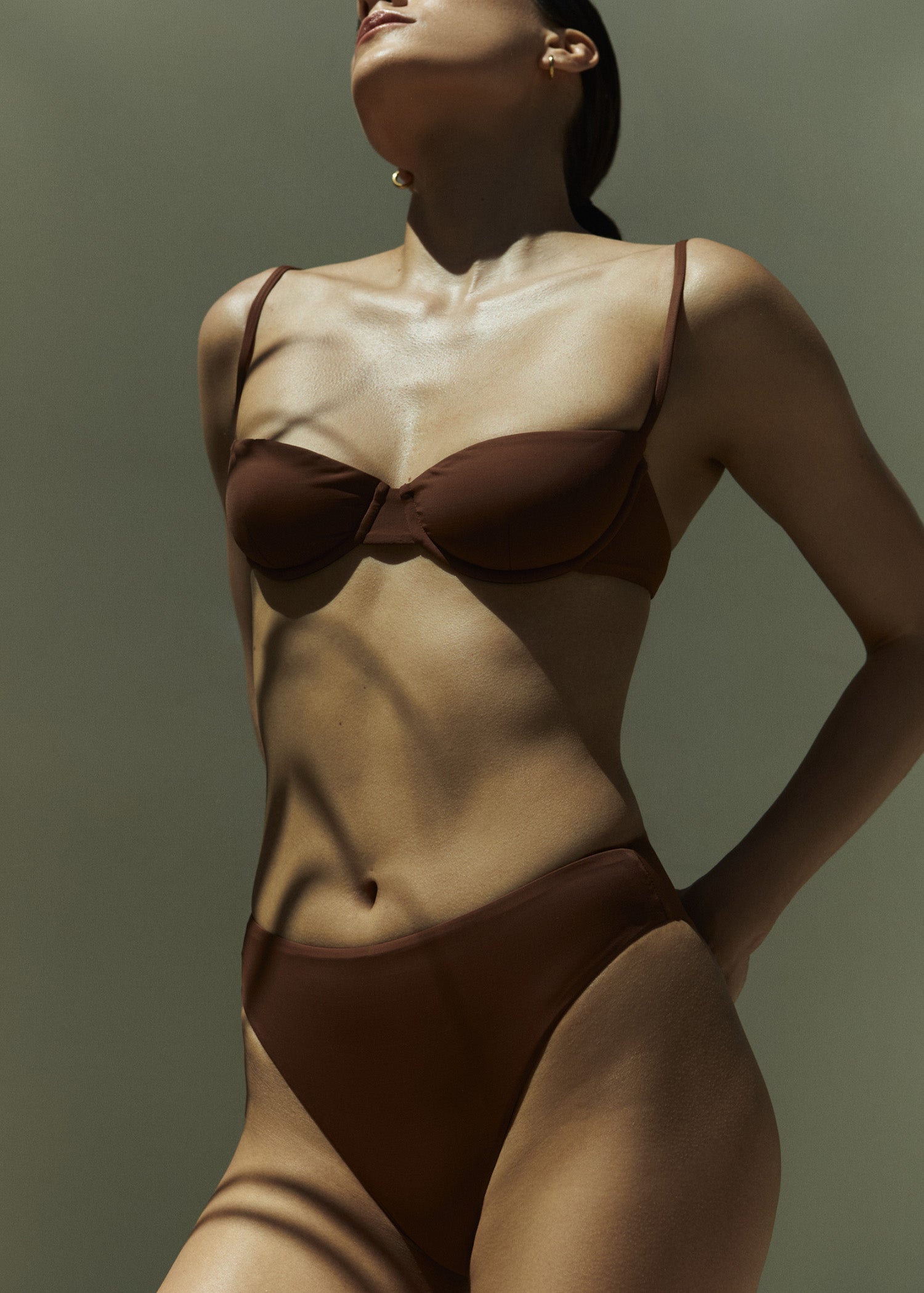 Model wearing the Balconette Underwire Bikini Top, designed to sit straight across the chest, it features light support and adjustable straps. 