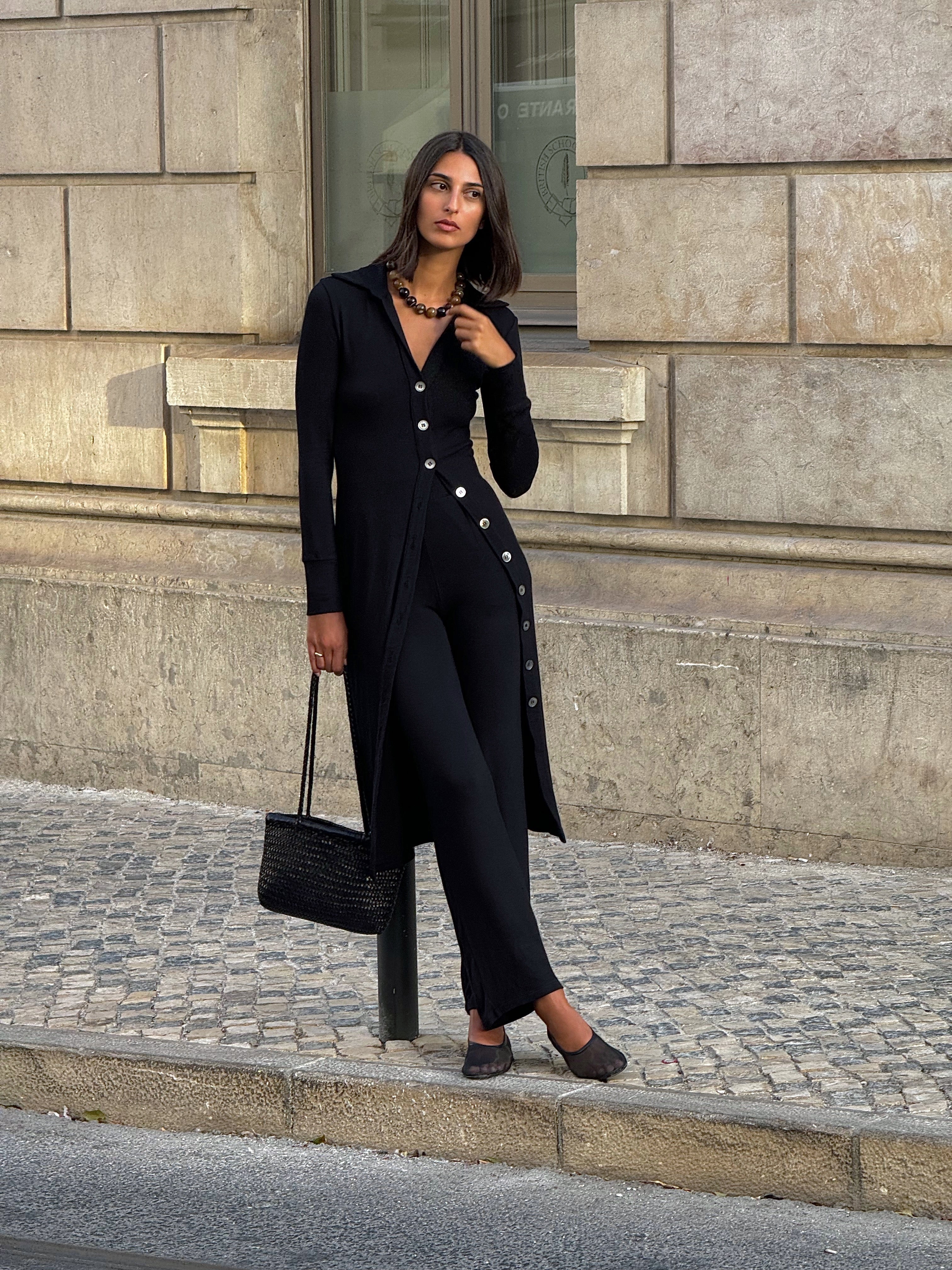 Cardigan Midi Dress in Modal Knit Black on Model with natural mother-of-pearl buttons and distinctive midi hem length, this look gives you coverage that feels uniquely modern.  