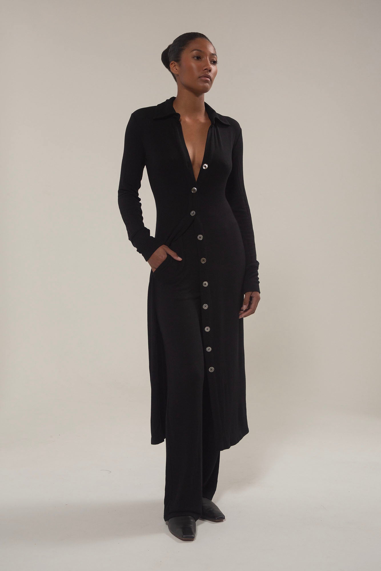 Model wearing Black Cardigan Midi Dress in Modal Knit with natural mother-of-pearl buttons and the distinctive midi hem length, this look gives you coverage that feels uniquely modern. 