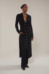 Model wearing Black Cardigan Midi Dress in Modal Knit with natural mother-of-pearl buttons and the distinctive midi hem length, this look gives you coverage that feels uniquely modern. 