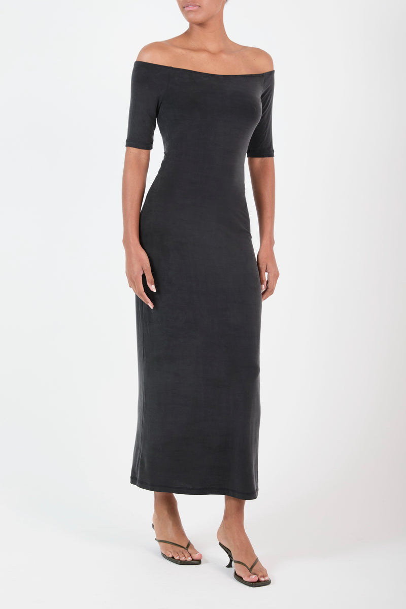 Ecomm Model wearing the Carolyn Off the Shoulder Midi Dress in Luxe Cupro Jersey, the graceful line of the neck continues to the shoulder and together with the elbow-length sleeve creating a moment of alluring and understated chic. 