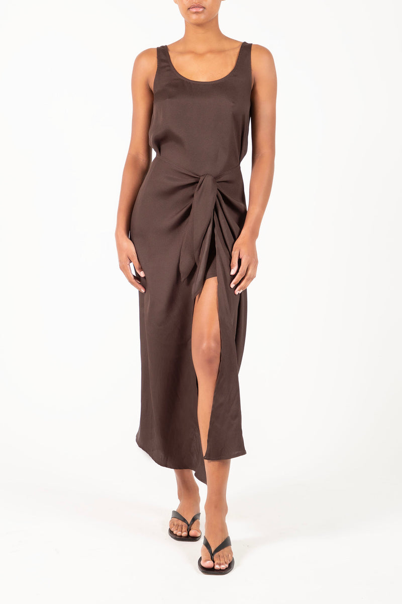 Ecomm Model wearing the D.K. Midi Wrap Dress in Matte Crepe, featuring a classic scoop neckline and self-tie skirt designed to be styled several ways.
