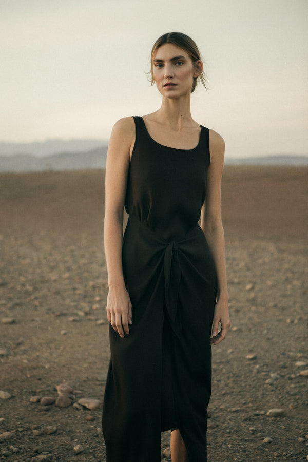 Model wearing the D.K. Midi Wrap Dress in Matte Crepe, featuring a classic scoop neckline and self-tie skirt designed to be styled several ways.