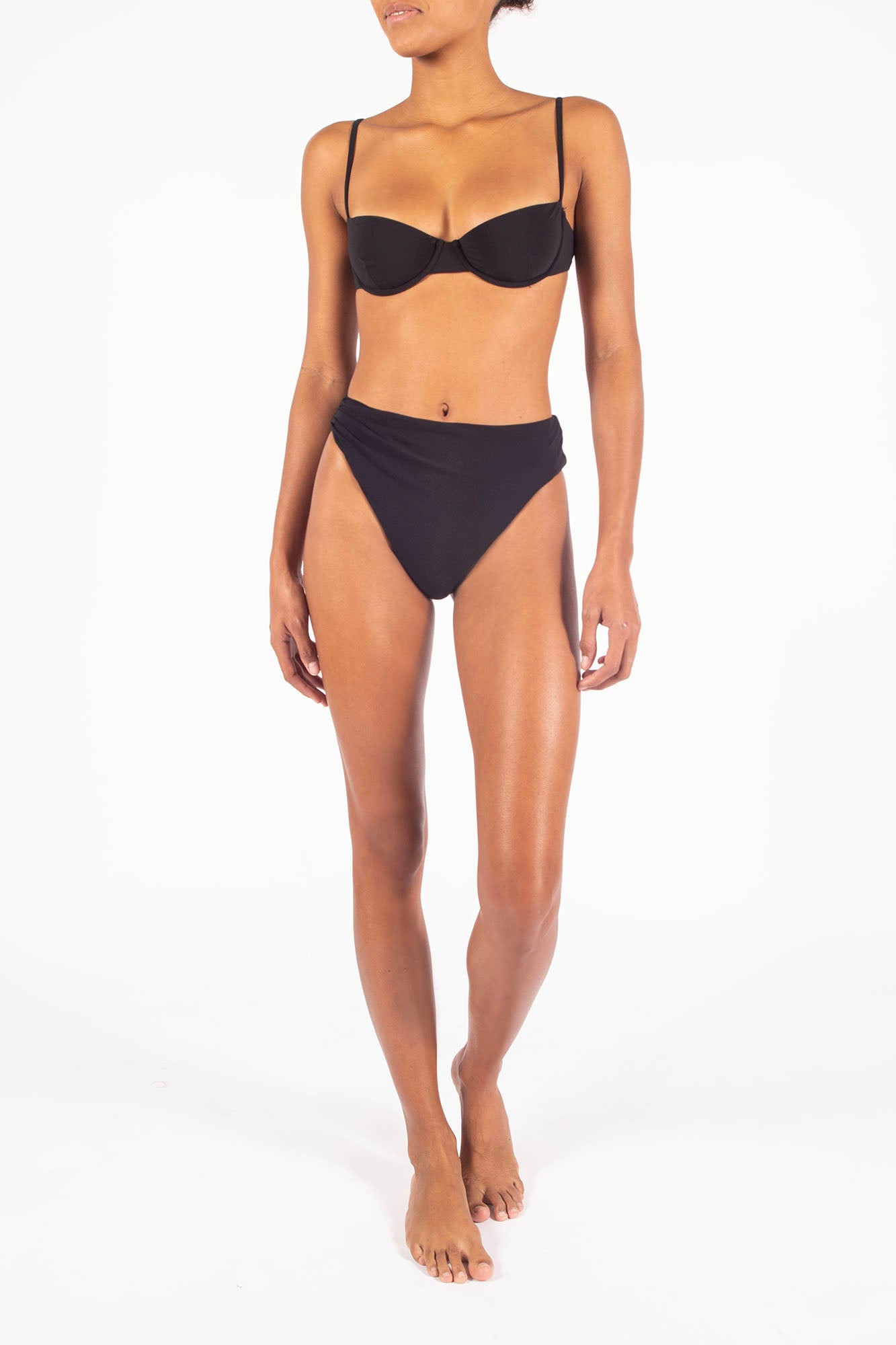 Draped Asymmetric Midi Bikini Bottom on Ecomm Model, featuring a distinctive, one-sided drape effect that translates the elegance of our ready-to-wear into swim: an irresistible mix of soigné and simplicity. 
