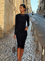 Draped Midi Dress in Modal Knit Black on Model with a long sleeve and distinctive draping, this look gives you coverage that feels uniquely modern.  