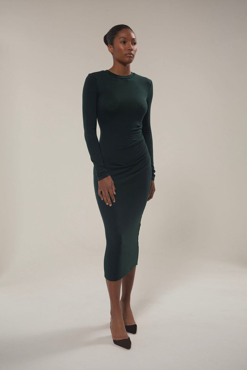 Draped Midi Dress in Modal Knit Dark Green on Model with a long sleeve and distinctive draping, this look gives you coverage that feels uniquely modern.  