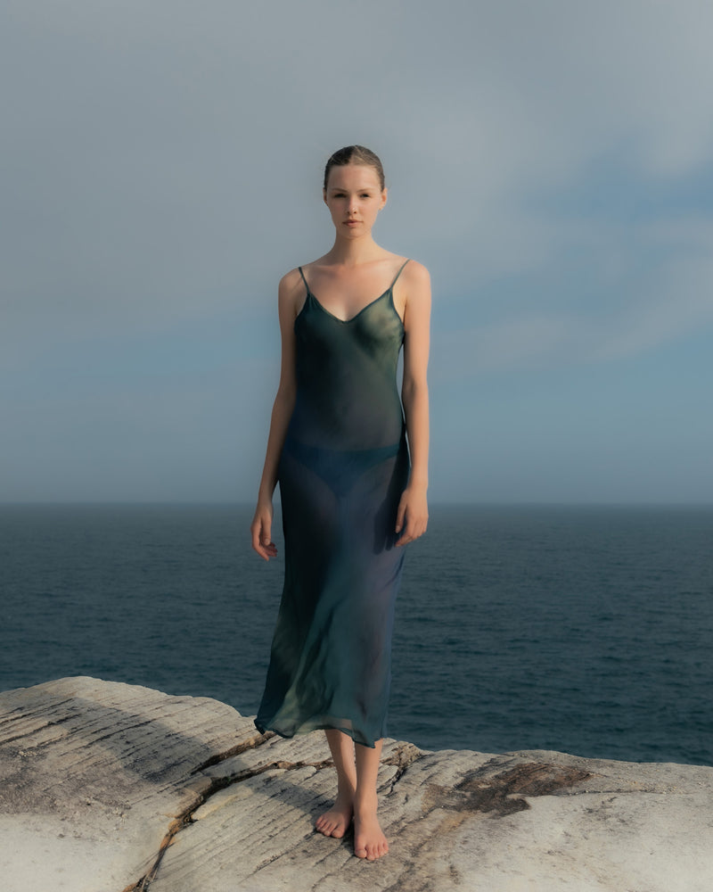 Model wearing the Harlow Bias-Cut Slip Dress in Sheer Ombre Eco-Chiffon, perfect as a chic cover-up or dressed up for beachside cocktails. 