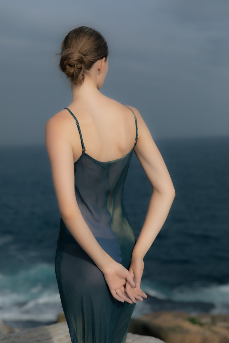 Model wearing the Harlow Bias-Cut Slip Dress in Sheer Ombre Eco-Chiffon, perfect as a chic cover-up or dressed up for beachside cocktails. 