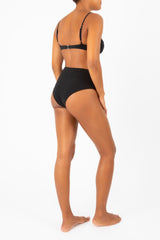 Ecomm Model wearing the High-Waist Bikini Bottom in Espresso Odd Stripes, featuring a high-rise fit that accentuates the waist and a cheeky cut for a modern, playful touch.