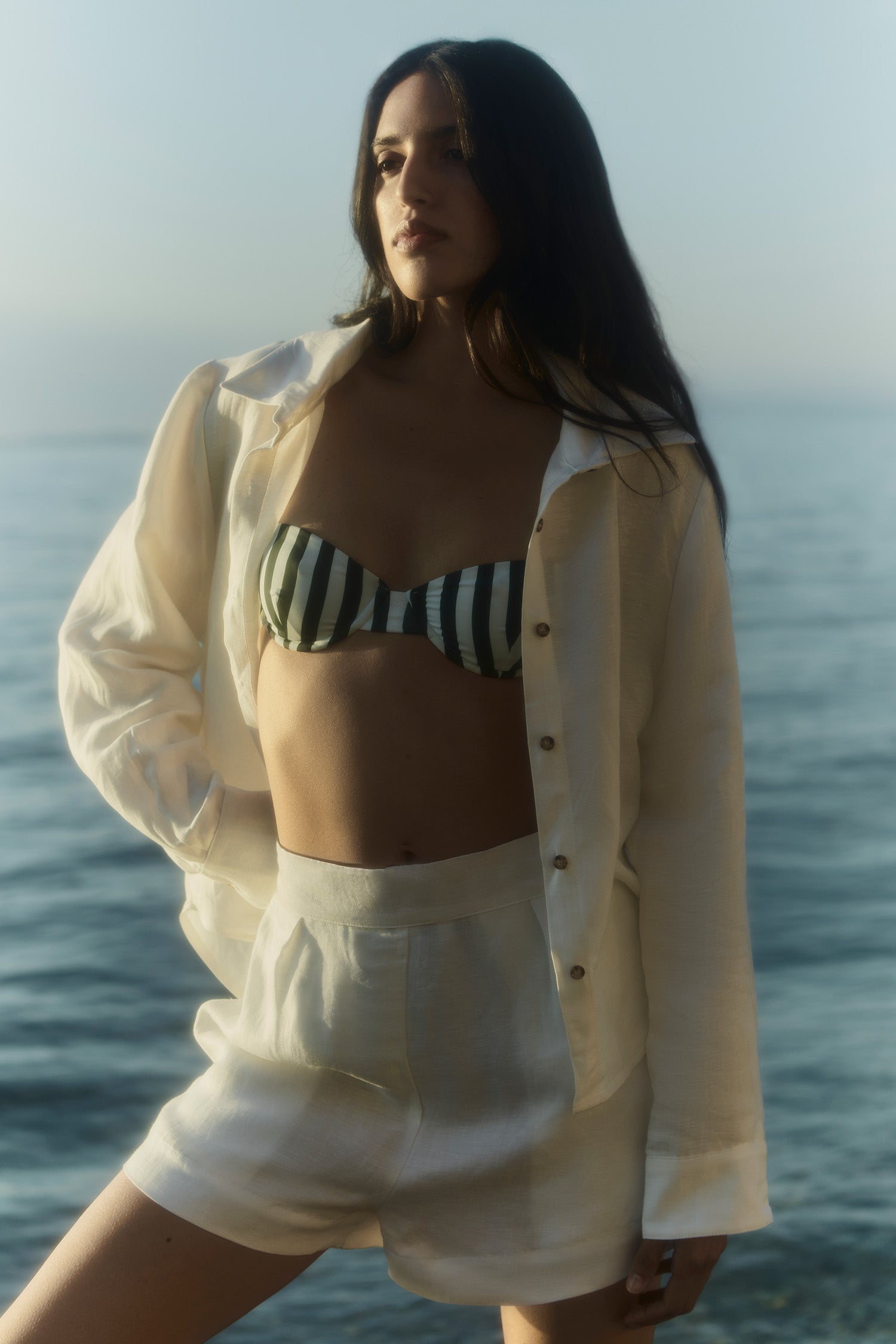 Model wearing the High-Waist Short Short in Linen Cupro, A feminine, high-waisted short short—an effortless, elevated update to classic boardshorts.