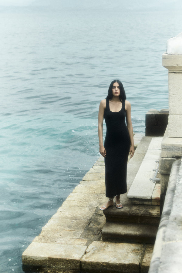 Model wearing Hume Tank Maxi Dress in Luxe Cupro Jersey, a utilitarian attitude meets sophisticated sex appeal in this versatile summer piece, perfect for poolside or a beach soiree.