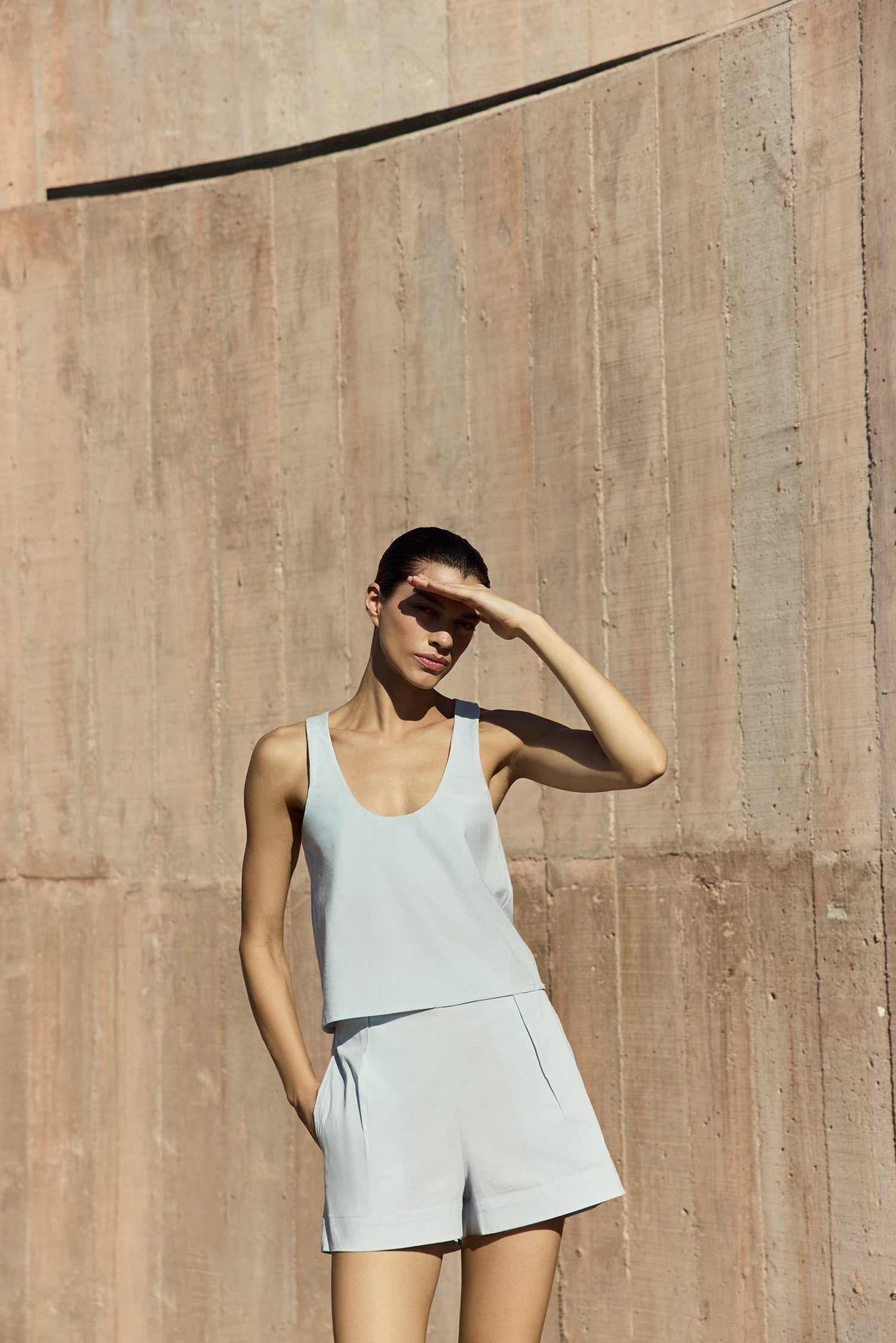 Model wearing Hume Tank Top in stretch cotton with a relaxed trapeze silhouette, styled as a versatile and effortless everyday piece.