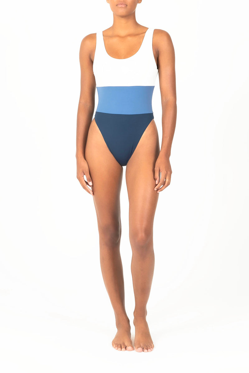 Ecomm Model wearing the Hume Tricolor One-Piece, featuring a dynamic high-cut, low-back design in two new tricolor styles.