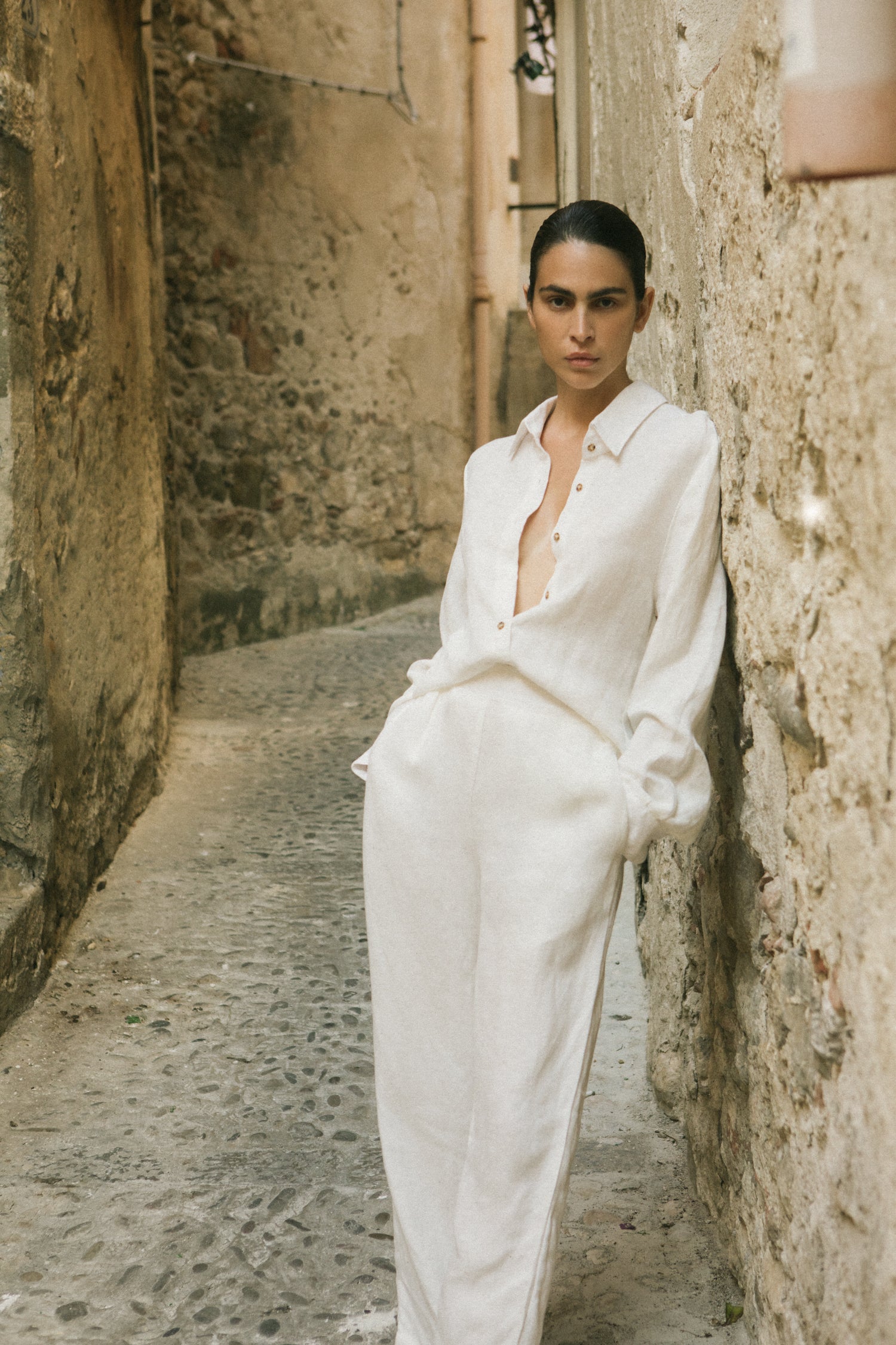 Model wearing the Keaton Wide Leg Pant in Linen Cupro, offering a high-waisted, relaxed, and refined silhouette with soft pleating and luxe fabric perfect for warm weather.