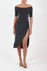 Ecomm Model wearing Knot Draped Midi Skirt in Luxe Cupro Jersey, recalling the classic drape of antiquity with a nonchalant tie and a daring side slit. 