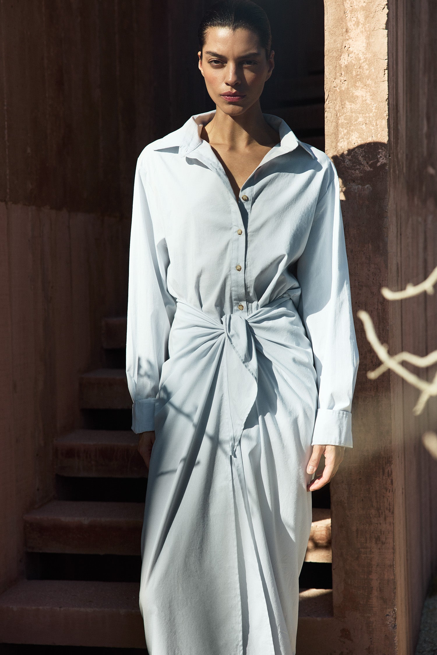 Model wearing L.A. Button-Down Wrap Midi Dress in stretch cotton, styled with a tailored wrap silhouette and relaxed shirt-inspired fit.