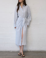 Model wearing L.A. Button-Down Wrap Midi Dress in stretch cotton, styled with a tailored wrap silhouette and relaxed shirt-inspired fit.