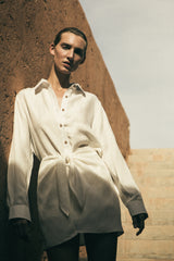 Model wearing the L.A. Button-Down Wrap Mini Dress in Cupro Linen Blend, featuring a button-down placket and chic wrap detailing along the waist. 