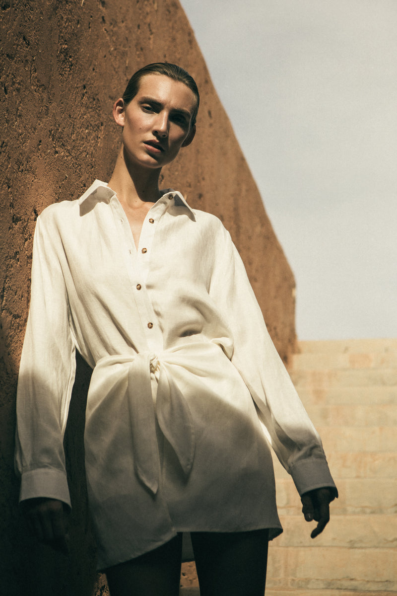 Model wearing the L.A. Button-Down Wrap Mini Dress in Cupro Linen Blend, featuring a button-down placket and chic wrap detailing along the waist. 