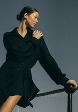 Model wearing the L.A. Button-Down Wrap Mini Dress in Matte Crepe, combining a classic wrap silhouette with an oxford-style button-down design in this signature matte crepe for a sleek, modern look.