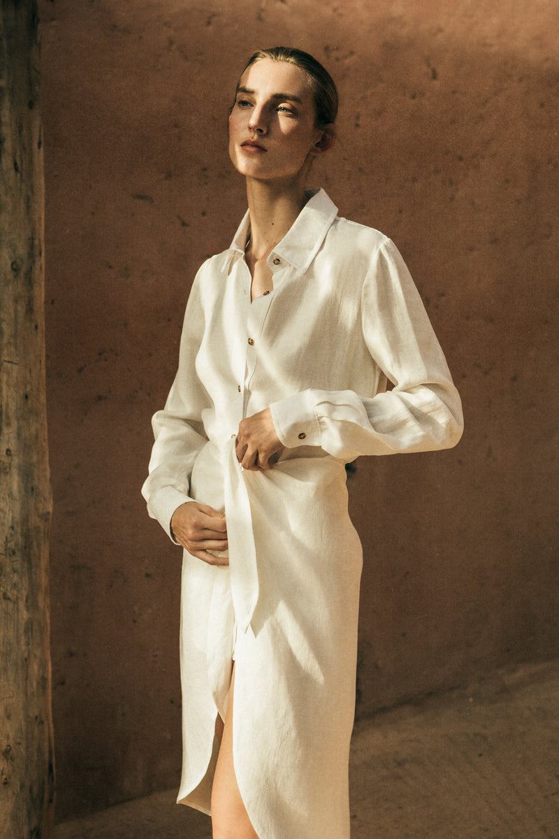 Model wearing the L.A. Button Down Asymmetric Wrap Midi Dress in Cupro Linen Blend, combining the structure of a button-down with the ease of a wrap silhouette. 
