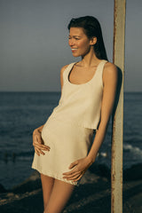 Model wearing the Mini Skirt in Stretch Suiting Off-White, an effortless, versatile piece perfect for spring and easy to pack for spontaneous beach trips.