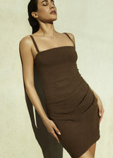 Model wearing the Nadege Draped Mini Dress Marron in Stretch Suiting, an effortless combination of ease and form in one simple piece.