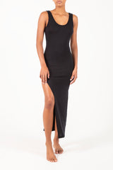 Ecomm Model wearing the Open Back Maxi Tank Dress with Side Slit in Modal Knit, featuring a high side slit for added movement and a plunging back for an elegant touch, making it a versatile wardrobe essential.