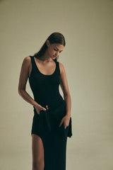 Model wearing the Open Back Maxi Tank Dress with Side Slit in Modal Knit, featuring a high side slit for added movement and a plunging back for an elegant touch, making it a versatile wardrobe essential.