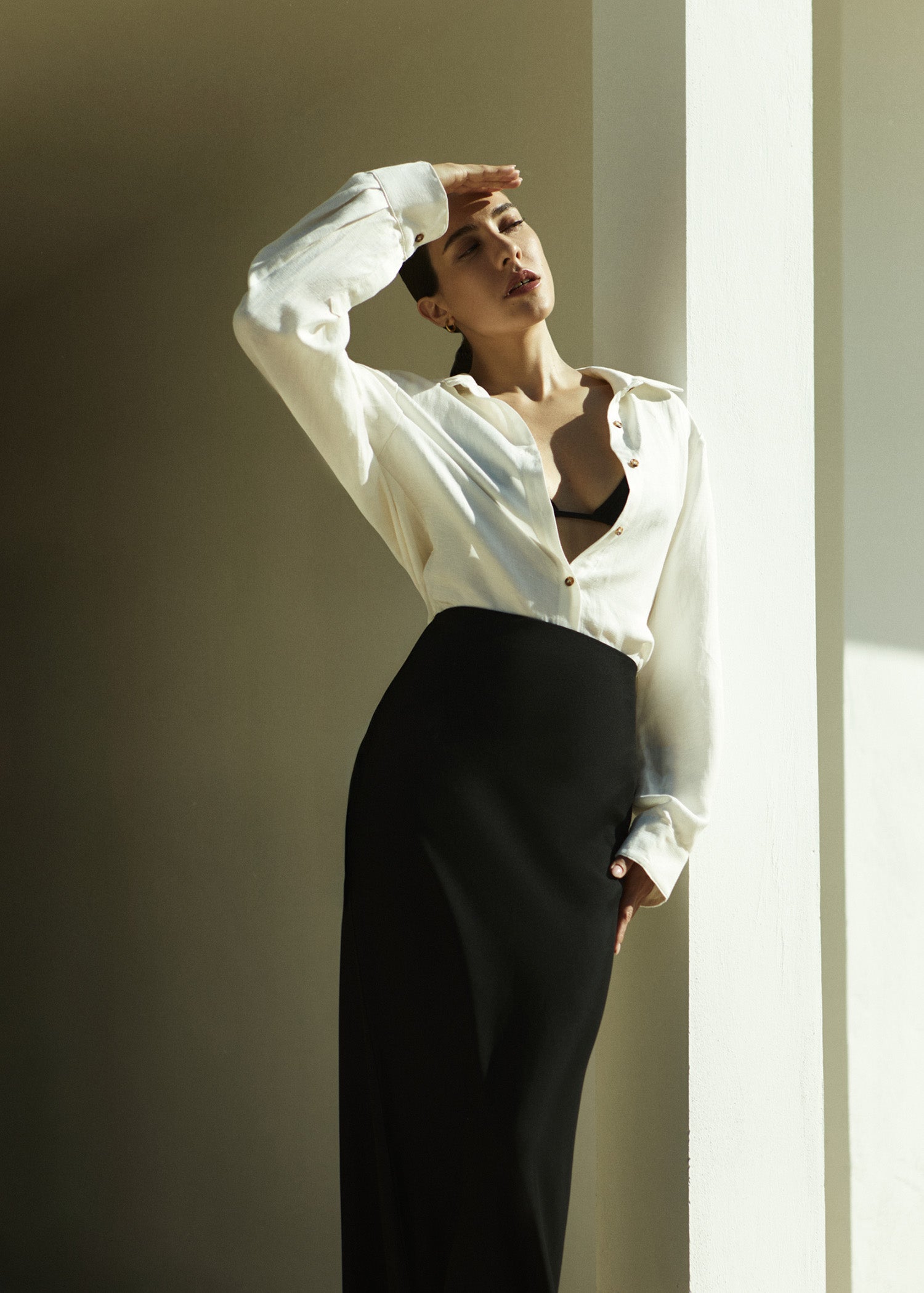 Model wearing the Phillips Long Sleeve Button-Down Shirt in Linen Cupro,  featuring a statement collar and drop shoulder for a retro feel.