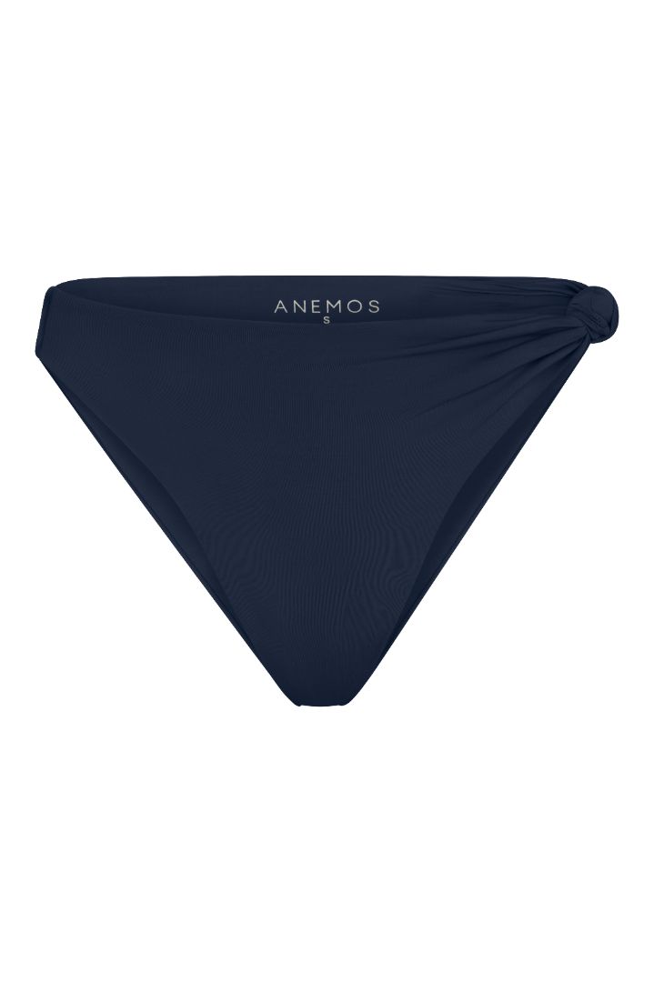 The Knot Asymmetric Midi Bikini Bottom on a white background, featuring a high-waist, high-cut leg, and knot detail at the hip for a retro-inspired, sculptural look. 