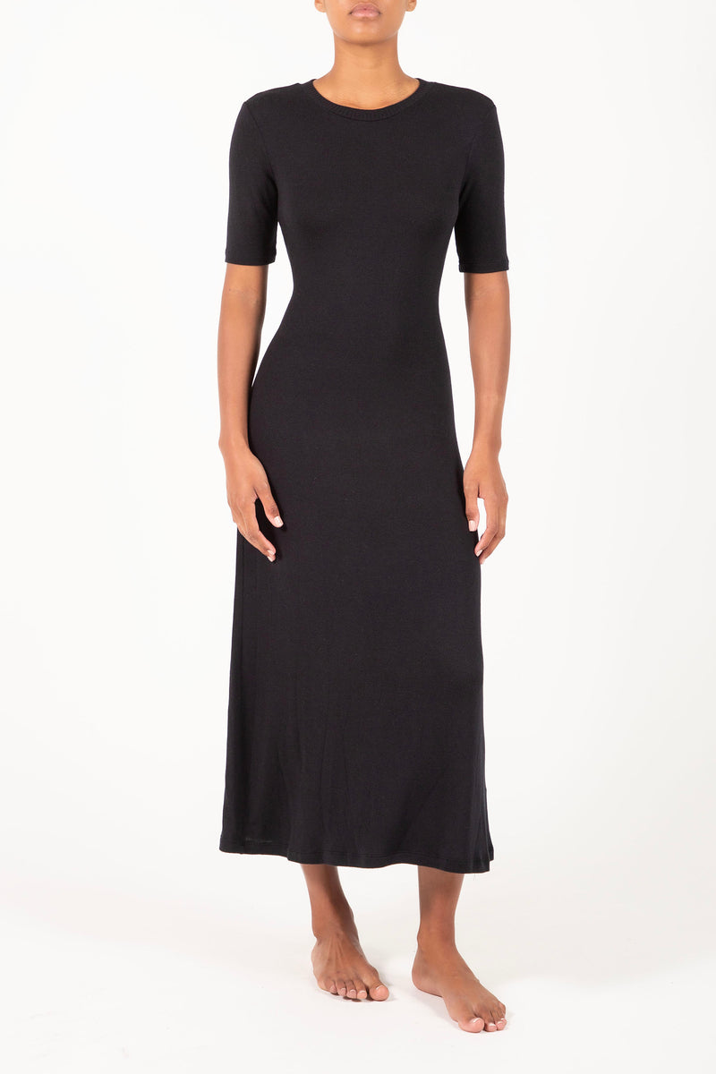 Ecomm Model wearing the Short-Sleeve Midi Dress in Modal Knit, featuring a sleeve that hits just above the elbow and the distinctive midi hem length, this look gives you coverage that feels uniquely modern.  