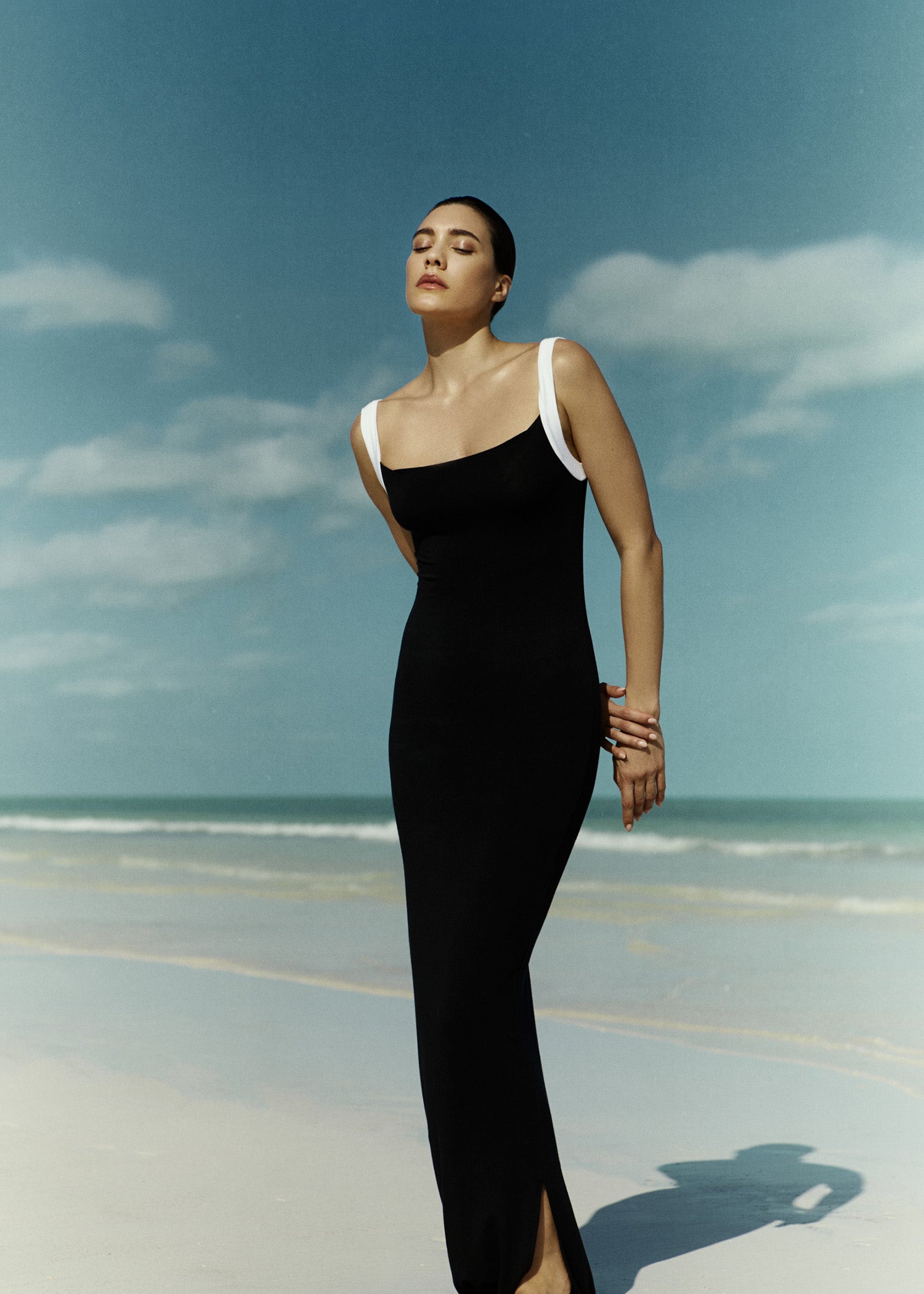 Model wearing the Square Neck Maxi Tank Dress In Black & White Contrast Strap Jersey, elevated by a bold white contrast strap offering a sleek elongated silhouette.