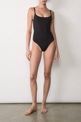 Ecomm Model wearing the Square Neck Open Back One-Piece, featuring a square neckline, sculpting waist seam, and cheeky fit in luxe, smoothing fabric. Runs small—size up for longer torsos.