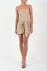 Ecomm Model wearing the Strapless D.K. Mini Wrap Dress in Textured Stretch, with the strapless neckline complementing the dynamic self-tie waist that makes this piece equally effortless and unforgettable.