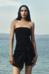 Model wearing the Strapless D.K. Mini Wrap Dress in Textured Stretch, with the strapless neckline complementing the dynamic self-tie waist that makes this piece equally effortless and unforgettable.