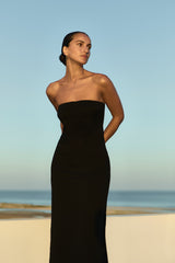 Model wearing the Strapless Midi Dress Black in Stretch Twill embodying minimalist elegance.