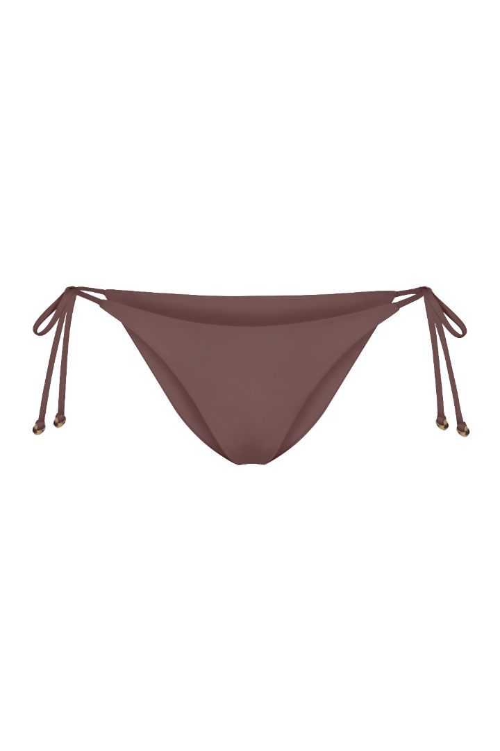 String Tie Bikini Bottom on a white background, featuring adjustable side ties with petite tortoise rings and a versatile high- or low-waist fit for a sleek ’70s-inspired look.