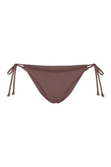 String Tie Bikini Bottom on a white background, featuring adjustable side ties with petite tortoise rings and a versatile high- or low-waist fit for a sleek ’70s-inspired look.