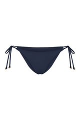 String Tie Bikini Bottom on a white background, featuring adjustable side ties with petite tortoise rings and a versatile high- or low-waist fit for a sleek ’70s-inspired look.