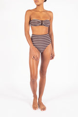 Ecomm Model wearing the Tortoise Bandeau Bikini Top In Espresso Odd Stripes, featuring a classic bandeau silhouette with an elongated resin tortoise ring and a wider fit for added comfort and support.