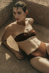 Model wearing the Tortoise Bandeau Bikini Top, elevated with a resin tortoise ring plus a roomier width for more comfort and security.