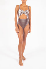 Ecomm Model wearing the Tortoise Cutout One-Piece In Espresso Mixed Stripes, featuring a distinctive tortoiseshell ring, a gathered bust, and a high waist for a look that’s both retro and relaxed. 